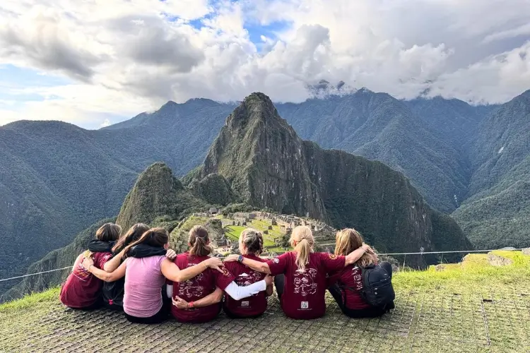 Trekkers reaching Machu Picchu with stunning views of the ancient citadel.